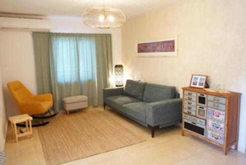 a living room with a couch and a chair at זמן מדבר in Mitzpe Ramon