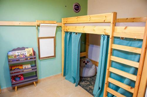 a bedroom with two bunk beds and a dog in it at זמן מדבר in Mitzpe Ramon