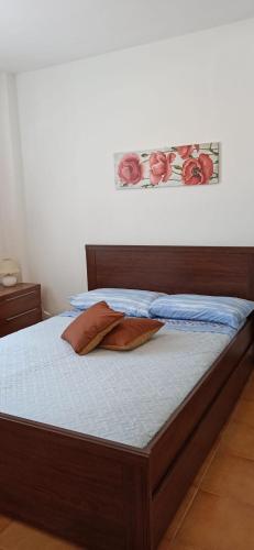 a bed with two pillows on it in a bedroom at Casa Daila in Costa de Antigua