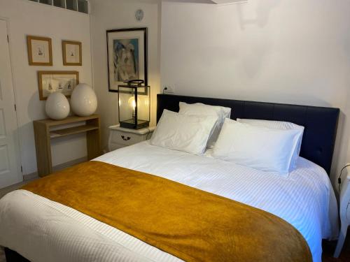 a bedroom with a bed with a yellow blanket on it at La Cigalière de l Isle in LʼIsle-sur-la-Sorgue
