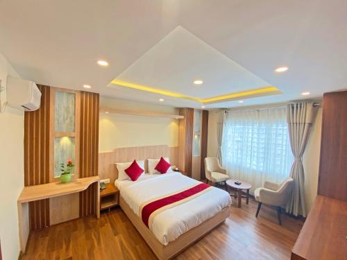 a hotel room with a bed and a table and chairs at Hotel Nilakantha Pvt. Ltd in Kathmandu