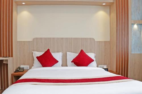 a bedroom with a large bed with red pillows at Hotel Nilakantha Pvt. Ltd in Kathmandu