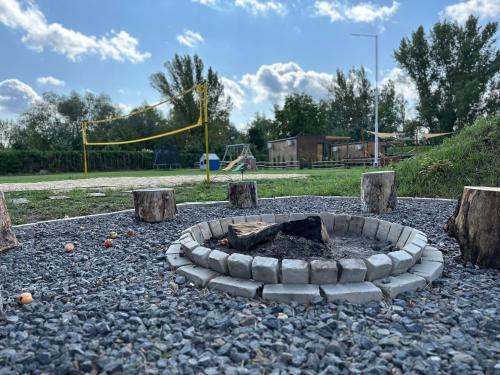 a fire pit in the middle of a playground at NAD BRZEGIEM WISŁY in Stężyca