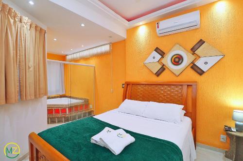 a bedroom with a bed with towels on it at Linda cobertura com jaccuzzi e terraço in Rio de Janeiro