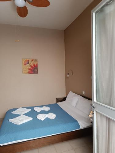 Ένα ή περισσότερα κρεβάτια σε δωμάτιο στο GIOTAS APARTMENTS - STUDIOS