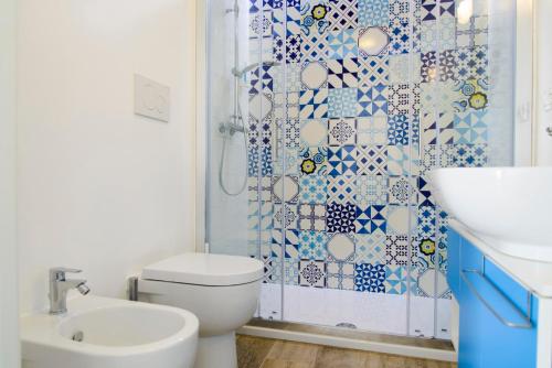 a bathroom with a white toilet and a shower at Le Palme Village in Terracina