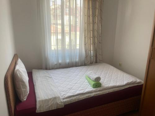 a small bed with a green stuffed animal on it at Central Exclusive Apartment/Penthouse in Bitola