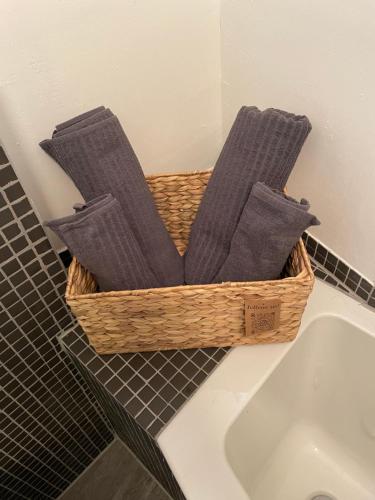 a basket of towels sitting next to a sink at Appartamento Kern-Sciare A Portata Di Mano- in Madesimo