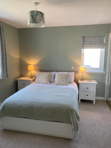 a bedroom with a bed with two night stands and two lamps at NEW pet friendly holiday home, sleeps 6, Stromness in Stromness