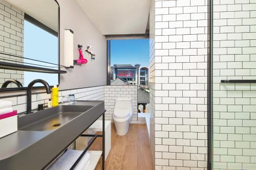 a bathroom with a sink and a toilet at Moxy Xi'an Downtown in Xi'an