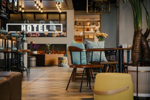 a restaurant with chairs and a table and a hotel at Moxy Xi'an Downtown in Xi'an