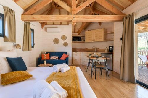 a bedroom with a large bed in a tiny house at Les Cabanes Suspendues in Satillieu