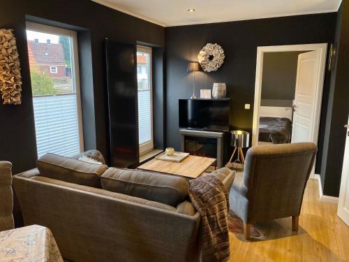 a living room with a couch and a table at country-suites by verdino LIVING - Apartments & Privatzimmer in Braunlage