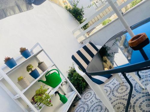 a balcony with a blue and white chair and plants at INANNA HOME in Bari