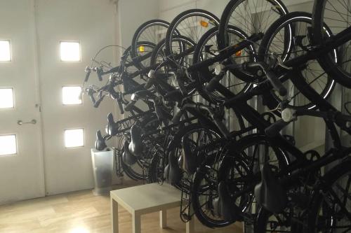 a bunch of bikes chained to a wall at Bright loft near the sea + BIKES in Valencia