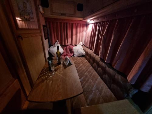 a wooden table in a room with a curtain at Mehefin Coed c/o llwyn Celyn in Whitechurch