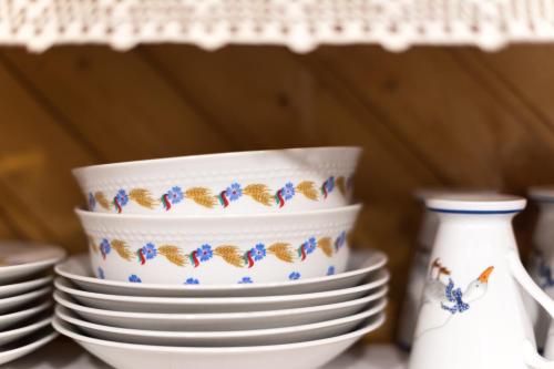 a stack of plates and bowls on a table at Saale Glück in Unterwellenborn