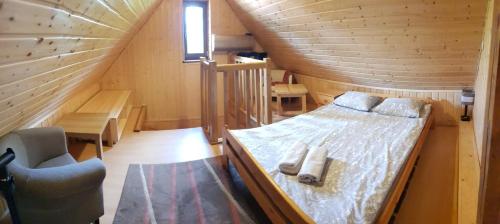 ストロニエ・シロンスキエにあるDom pod Wilczyńcemの木造キャビン内のベッド1台が備わるベッドルーム1室を利用します。