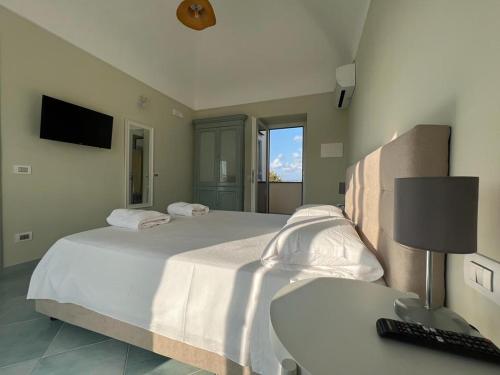 a bedroom with two beds and a desk with a keyboard at Palazzo Palumbo in Procida