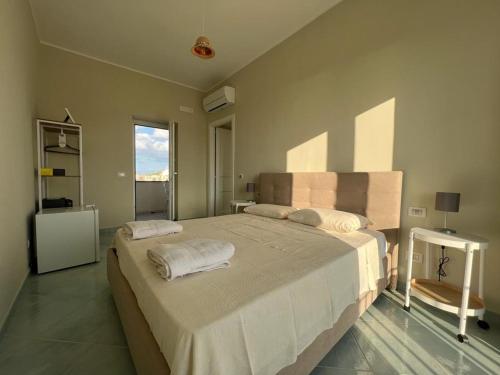 a bedroom with a large bed with towels on it at Palazzo Palumbo in Procida