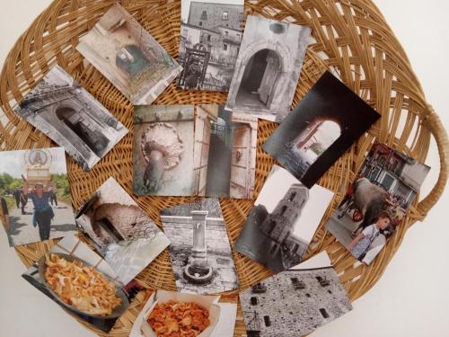 a basket filled with pictures of monuments and a plate of food at Bnb Peter Pan in San Martino dʼAgri