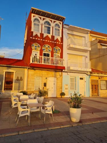 a patio with tables and chairs in front of a building at FirstLine BeachView in El Campello