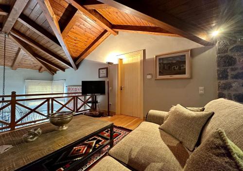 a living room with a couch and a table at Plethora Arachova Luxury Chalet in Arachova