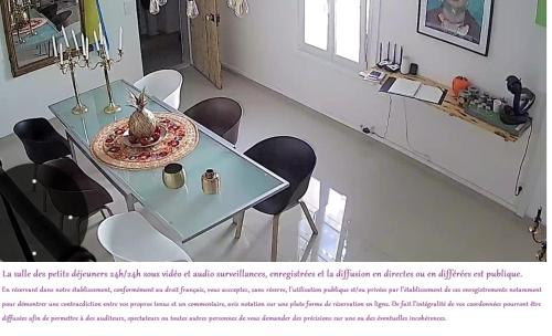 a dining room table with chairs and a table at Suite Privée Bed and Breakfast in Nîmes