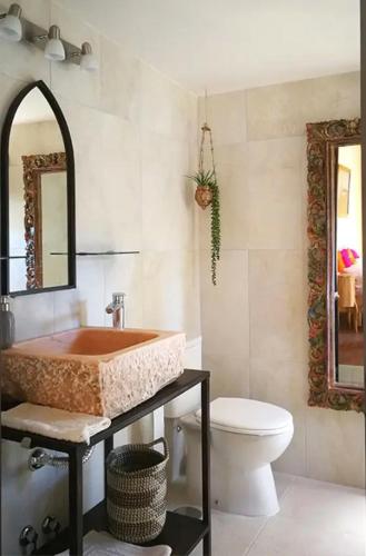 a bathroom with a sink and a toilet at Finca verde de la luz in Barbate