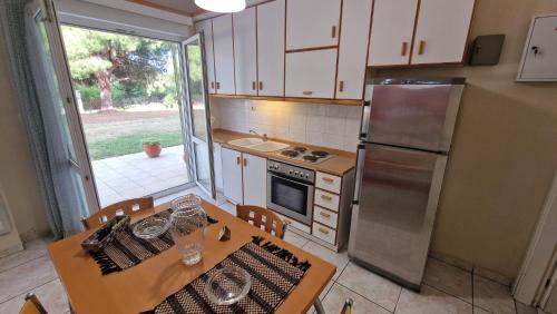a kitchen with a table and a refrigerator at Modern Sea Villa in Leptokaria in Leptokaria