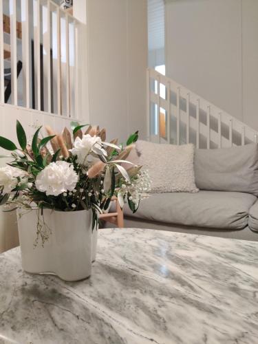 a vase of flowers sitting on a table in a living room at Sunstar Villa in Rovaniemi