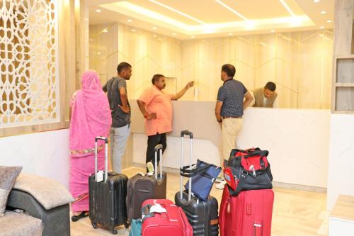 a group of people standing in a room with luggage at Hotel Nilakantha Pvt. Ltd in Kathmandu