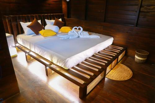 a bed with towels and shoes on top of it at Coco Palm Villa and Cabanas in Tangalle