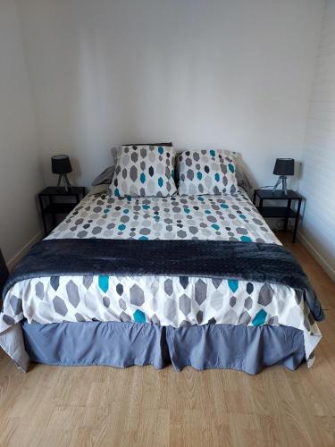 a bed in a bedroom with two pillows on it at L'esquiróu in Rocbaron