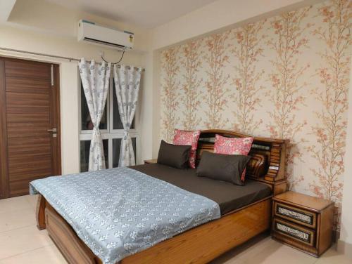 a bedroom with a bed and a window at The Ganges View Luxury Penthouse by iTvara in Rishīkesh