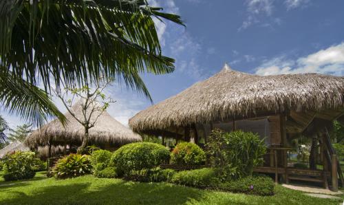 a group of huts with a grass roof at Hijo Resorts Davao in Tagum