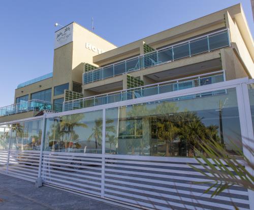 a building with a white fence in front of it at Hotel Vicino al Mare - Frente mar in Guarujá