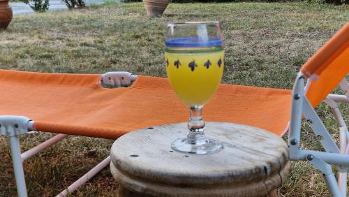 a glass of juice sitting on top of a chair at Modern Sea Villa in Leptokaria in Leptokaria
