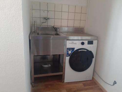 a kitchen with a sink and a washing machine at Apartment mit Balkon in Lünen in Lünen