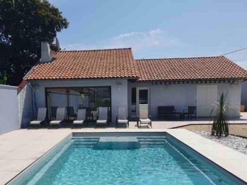 una piscina frente a una casa en Villa Moderne + Guest House + Piscine chauffée, en Gujan-Mestras