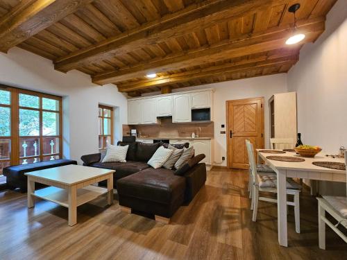 a living room with a couch and a table at Apartmány Jezerné in Velké Karlovice
