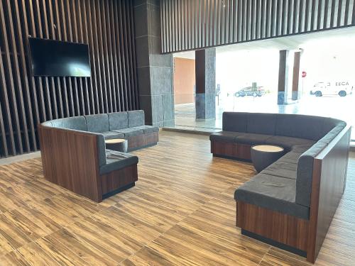 a lobby with a couch and chairs and a tv at Bali Residence Melaka near Jonker Street in Melaka