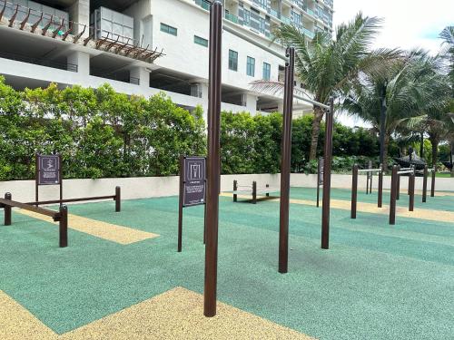a park with benches and signs in front of a building at Bali Residence Melaka near Jonker Street in Melaka
