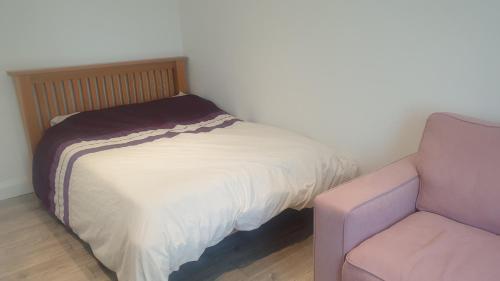 a bed and a chair in a room at Apsley home, Hemel Hempstead in Hemel Hempstead