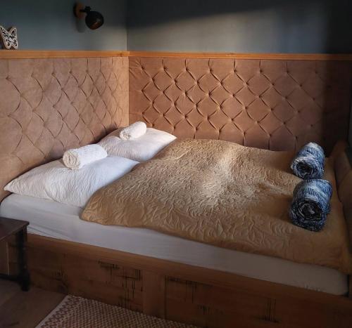 a bed with two towels and a stuffed animal on it at Marókahegy in Zalakaros