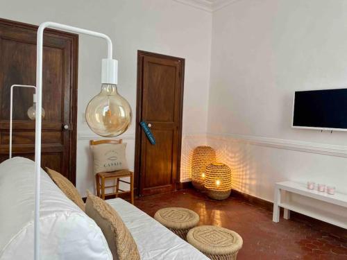 a bedroom with a bed and a tv and a table at Click! Casa Lamartine Fabulous Ideal Location Walk to ALL!!! in Cassis