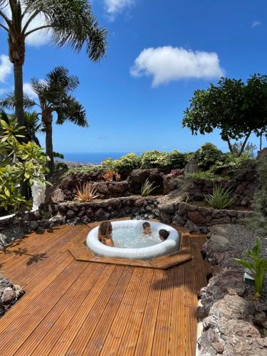 two dogs sitting in a hot tub on a deck at Casa Las Colinas- Preciosa Villa Isleña in La Orotava
