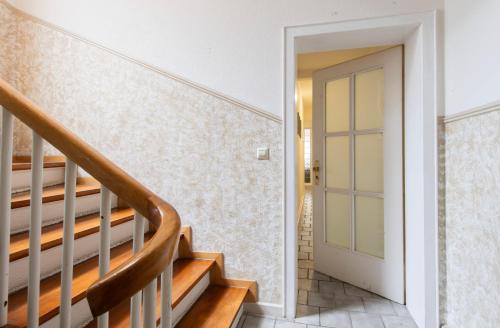 a staircase in a house with a glass door at City Center Apartment Kleve in Kleve