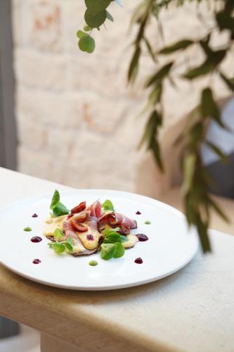 a white plate with food on a table at Masseria Grieco in Ostuni