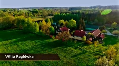 a green frisbee flying over a house in a field at Willa Reglówka in Wola Krakowiańska